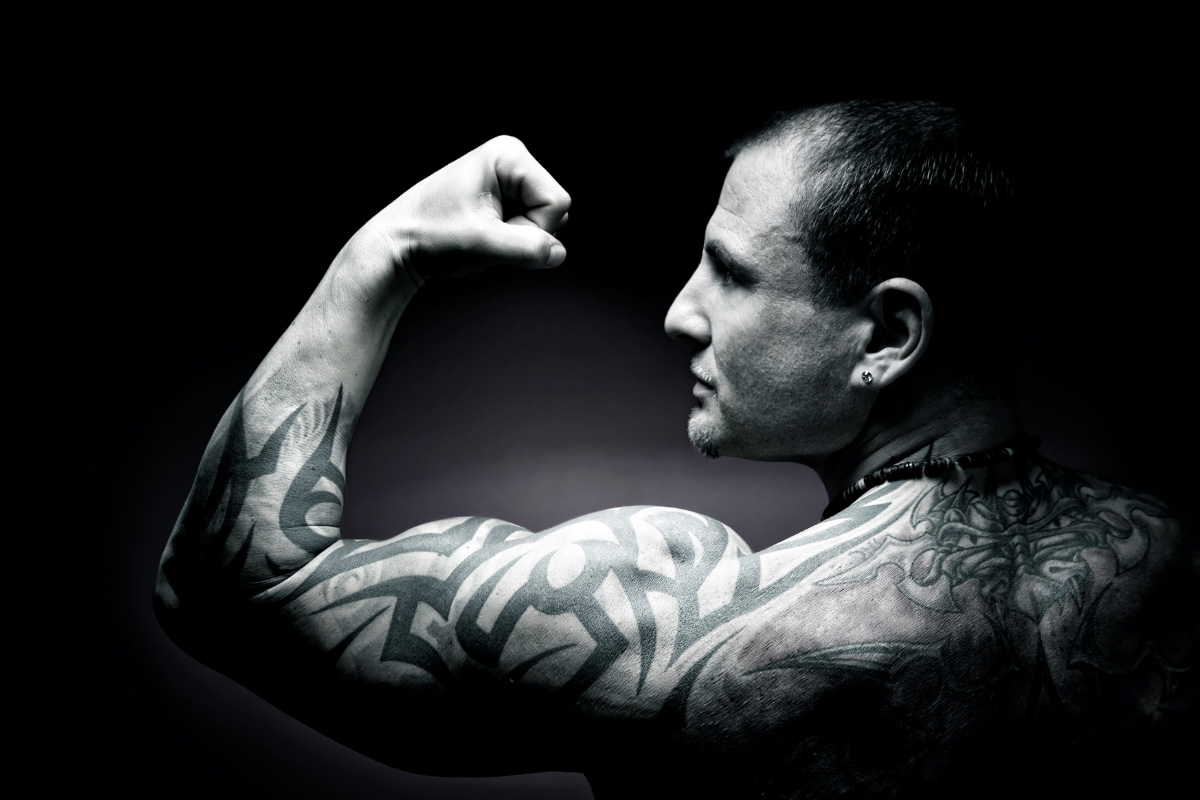 man with arm tattoos and muscles facts about tattoos