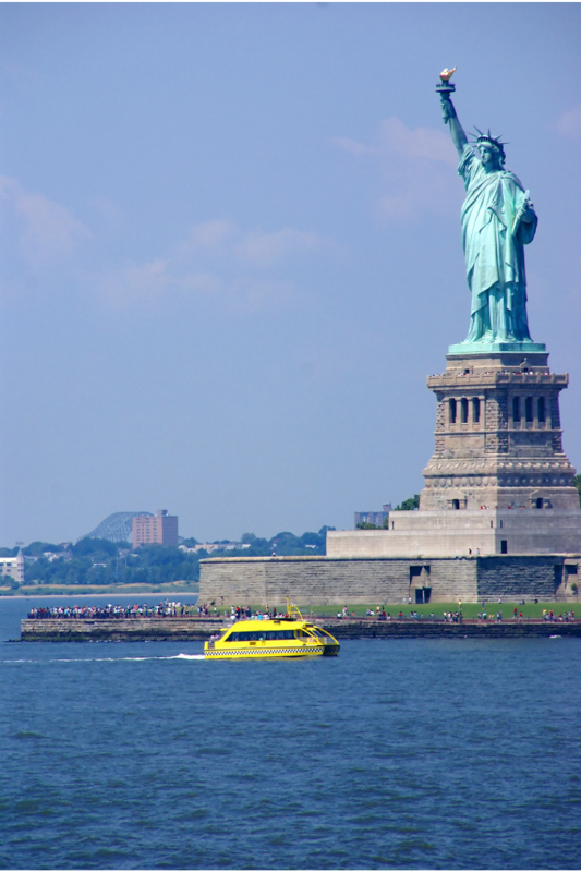statue of liberty and yellow boat