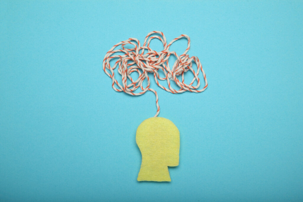 55 Facinating Psychology Facts About Love (2022) Most People Don't Know 19 In the middle of a light blue background surface lies a flat head shape piece of yellow paper and scribbled strings just above the head that seems to represent a thinking mind.