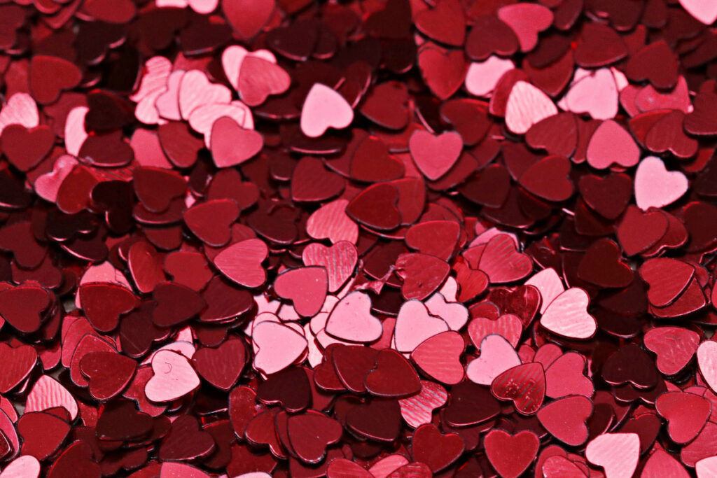 A pile of small flat pink heart pieces.