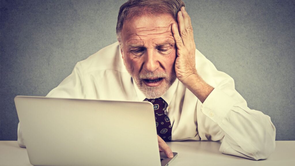 confused old man tired at his computer