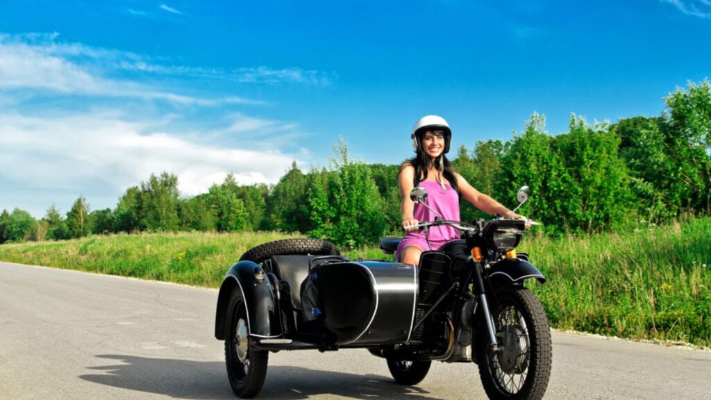 A girl riding a bike with a sidecar, Beautiful green background behind