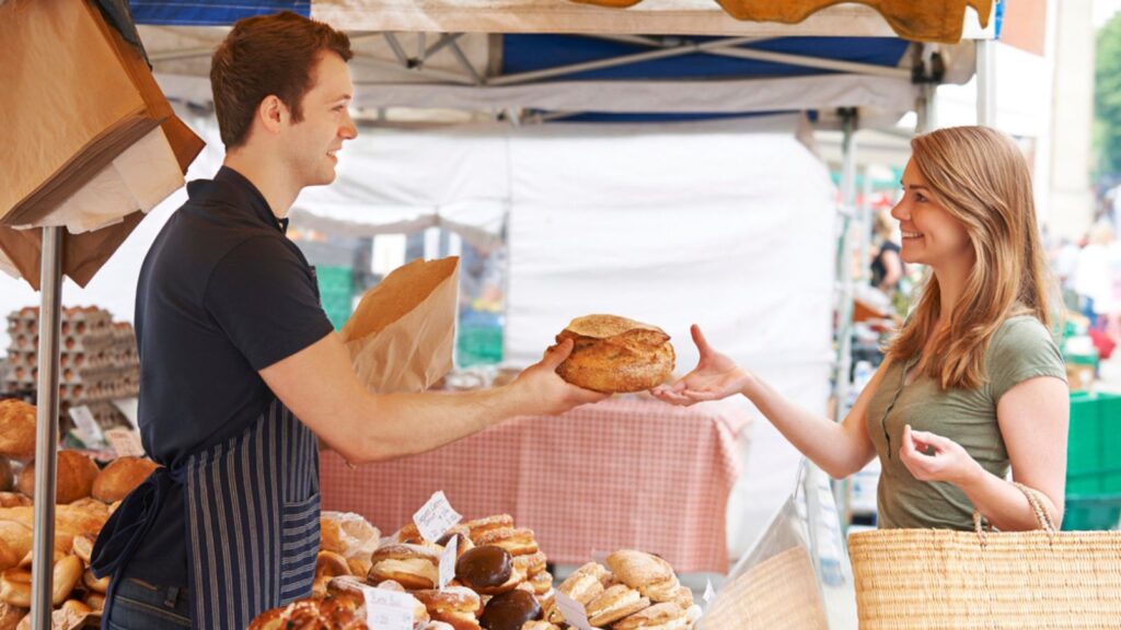 A woman buying Economical Food from a Bread Stall
