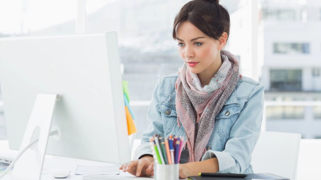 Casual woman using computer in office