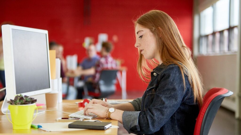 Confident female designer working at her desk