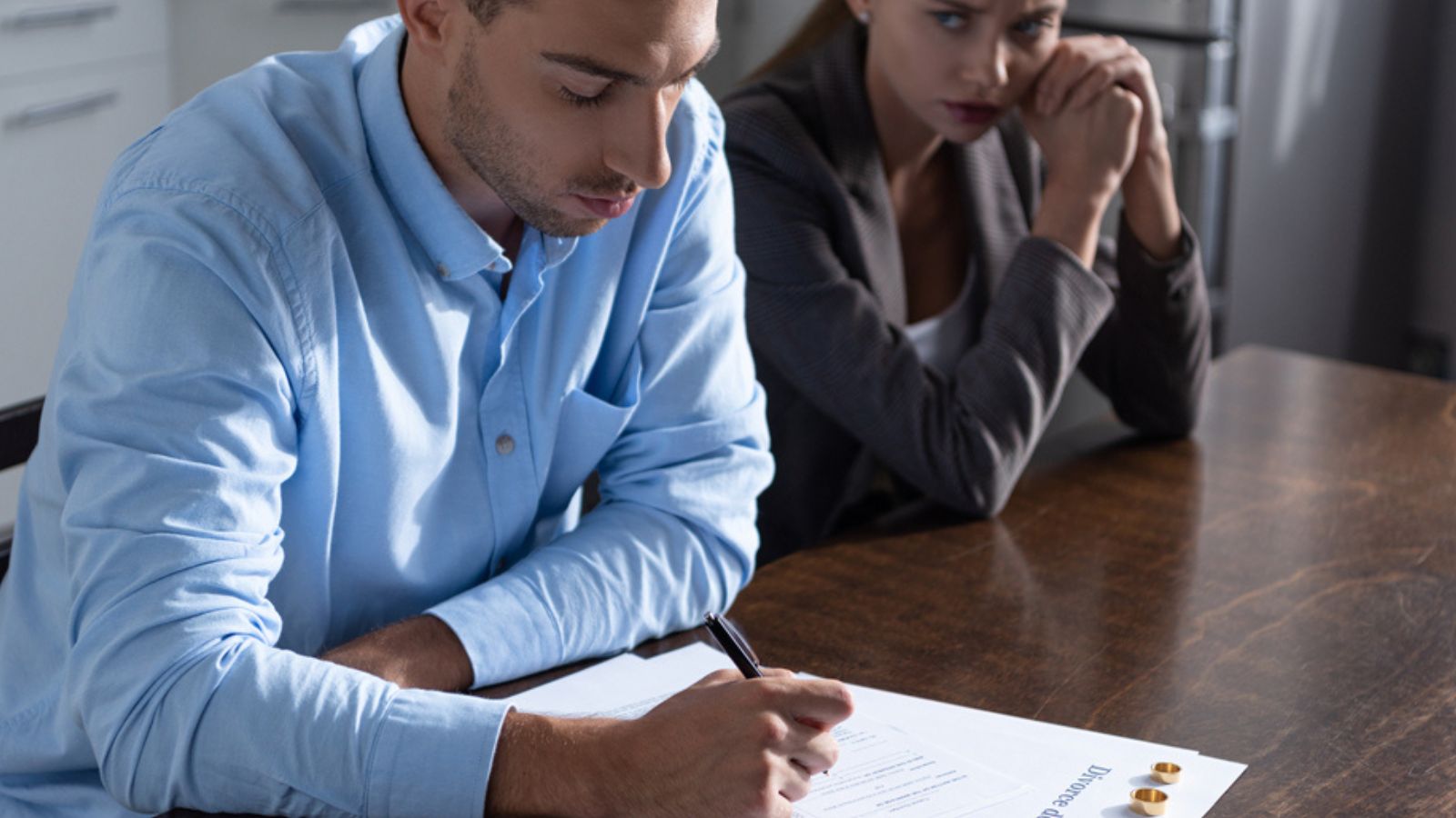Couple with divorce documents at table at home —