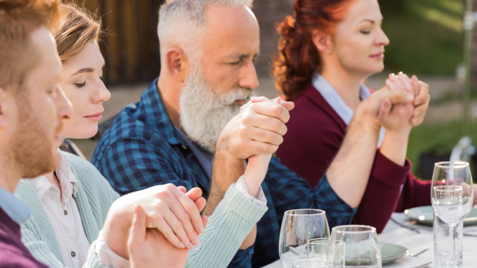 Family praying during dinner