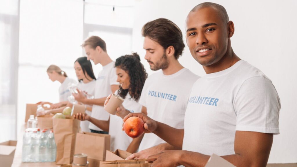 Volunteer packing food into bag