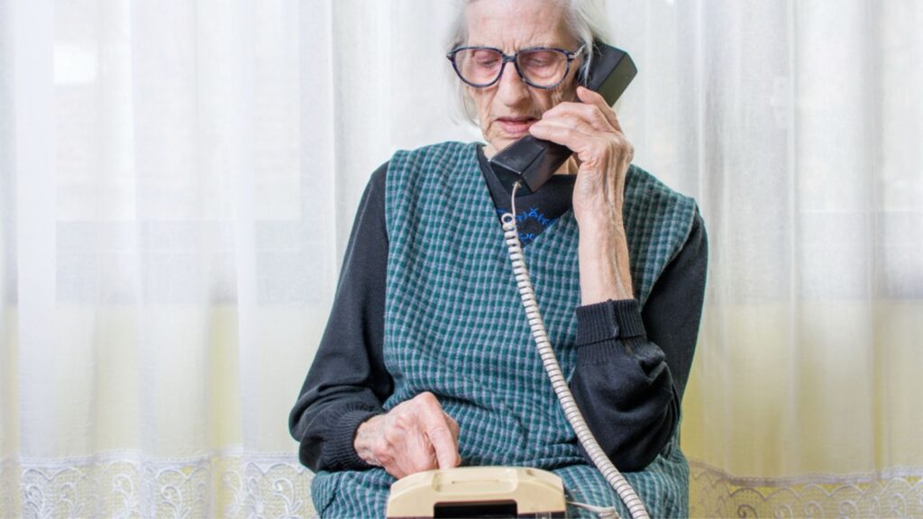 Old woman Talking on Old Landline Phone