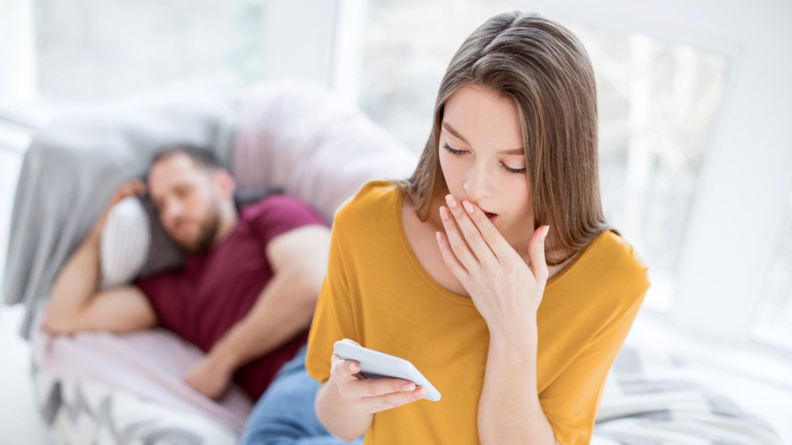 Startled woman checking her mans phone