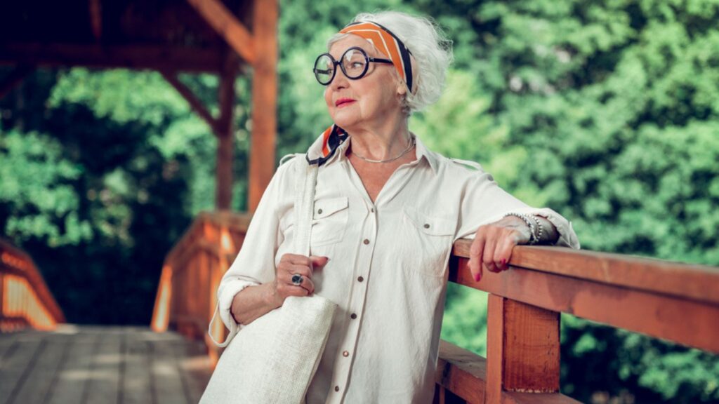 chic fashionable old woman outside with glasses and head scarf
