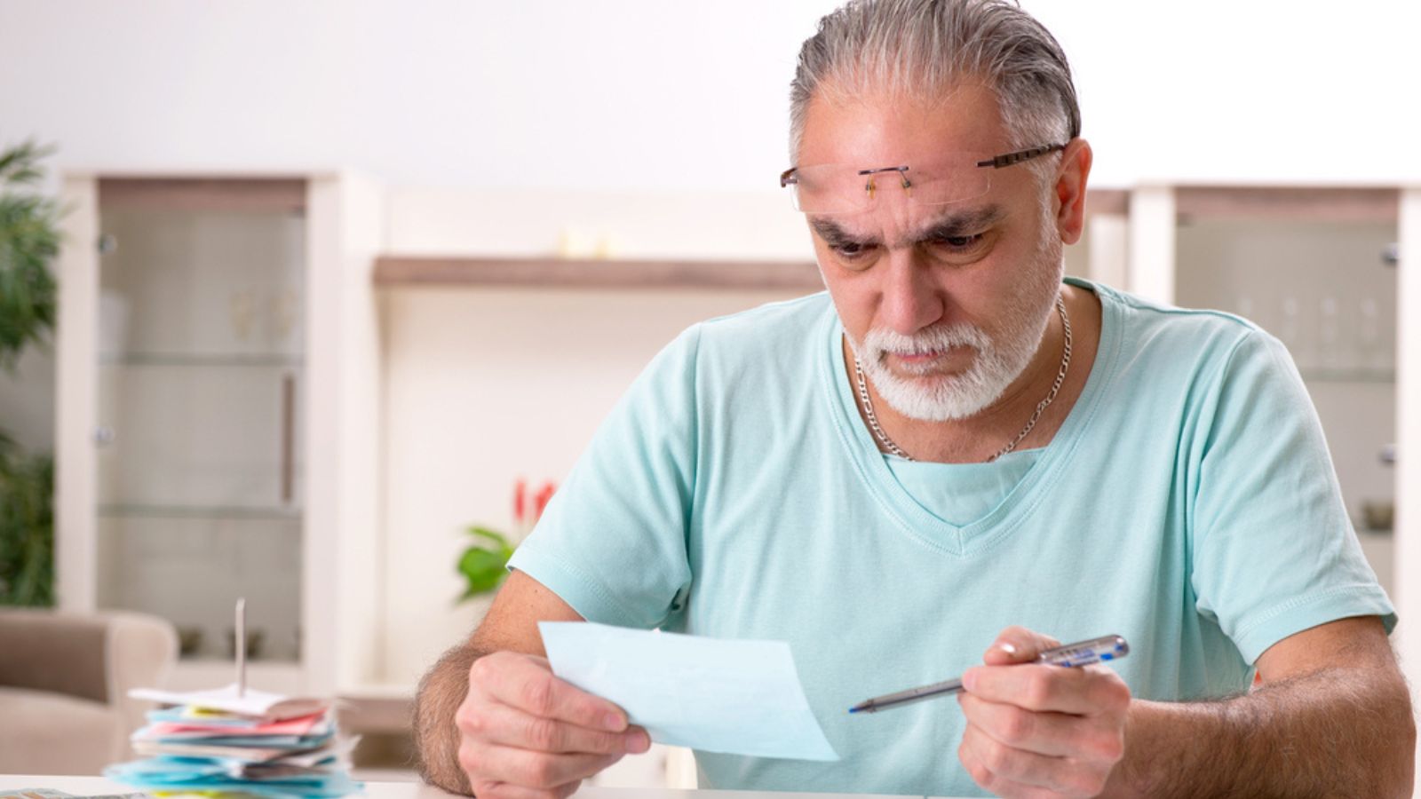 White bearded old man in budget planning concept