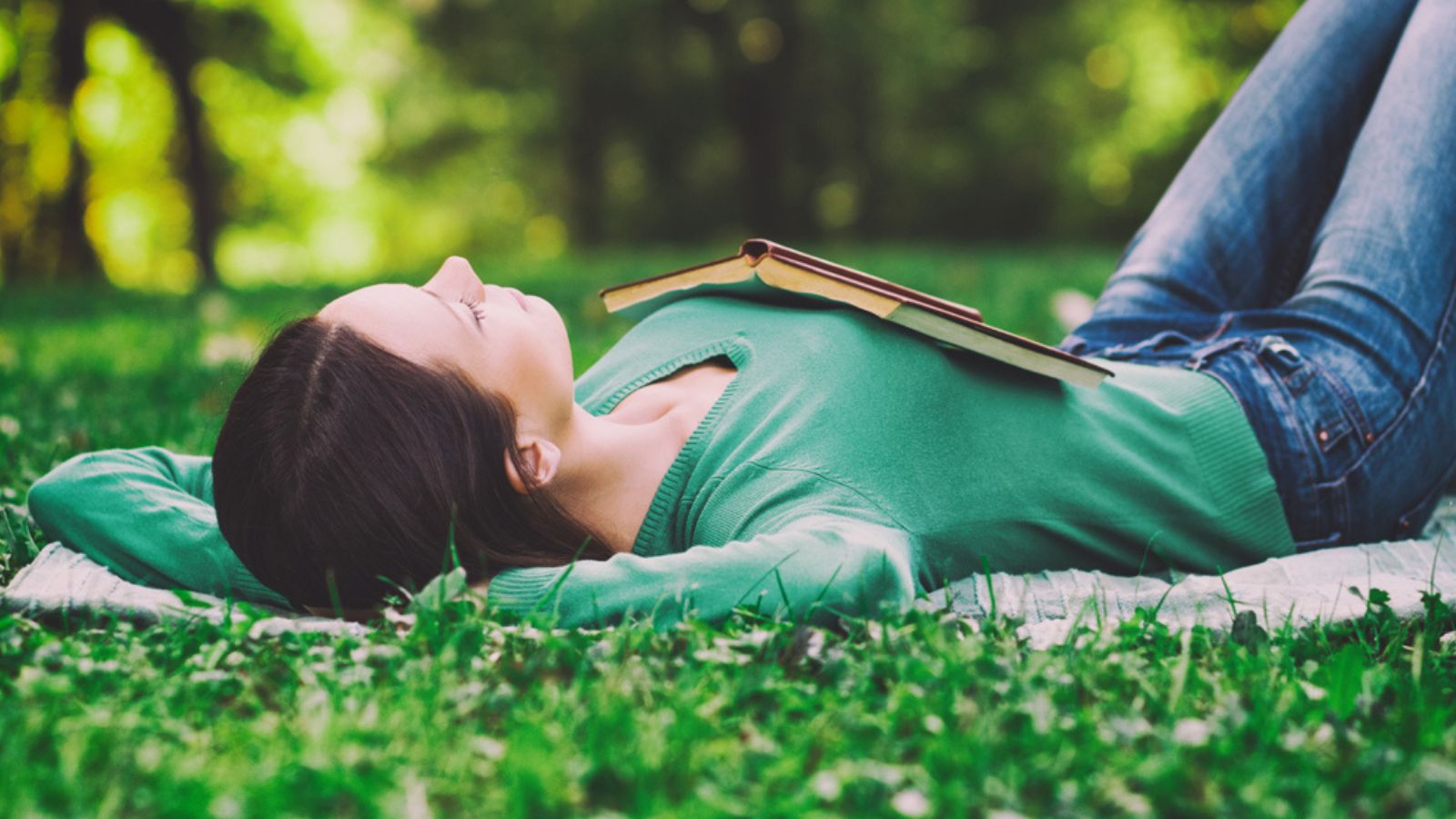 Woman lying down in nature and sleeping