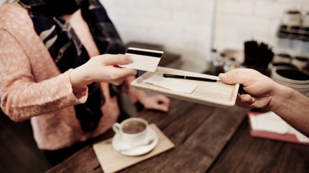 Woman pays bill credit card