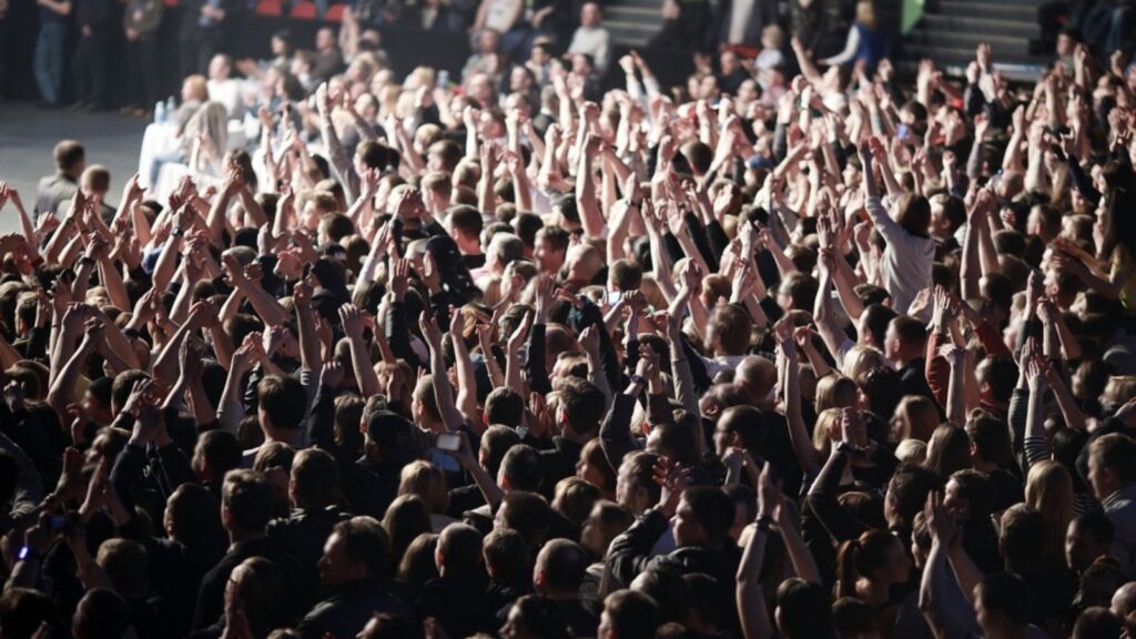 crowd in a rock concert waving their hands up