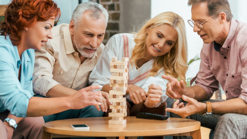 family or friends playing a happy game of jenga
