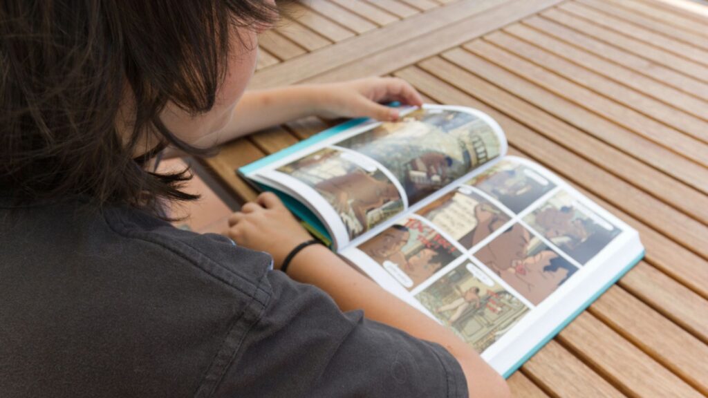 Boy reading comic book (1)