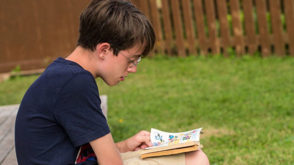 Boy reading comic book