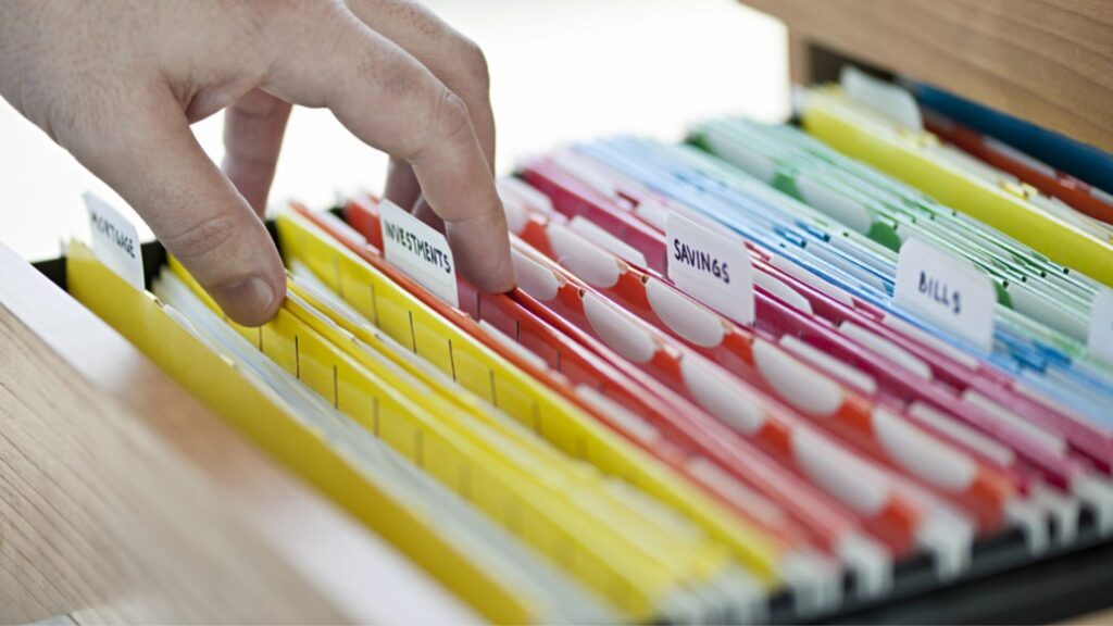 Financial documents in folders on drawer