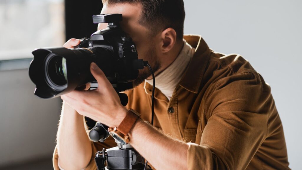 Photographer taking photo with digital camera