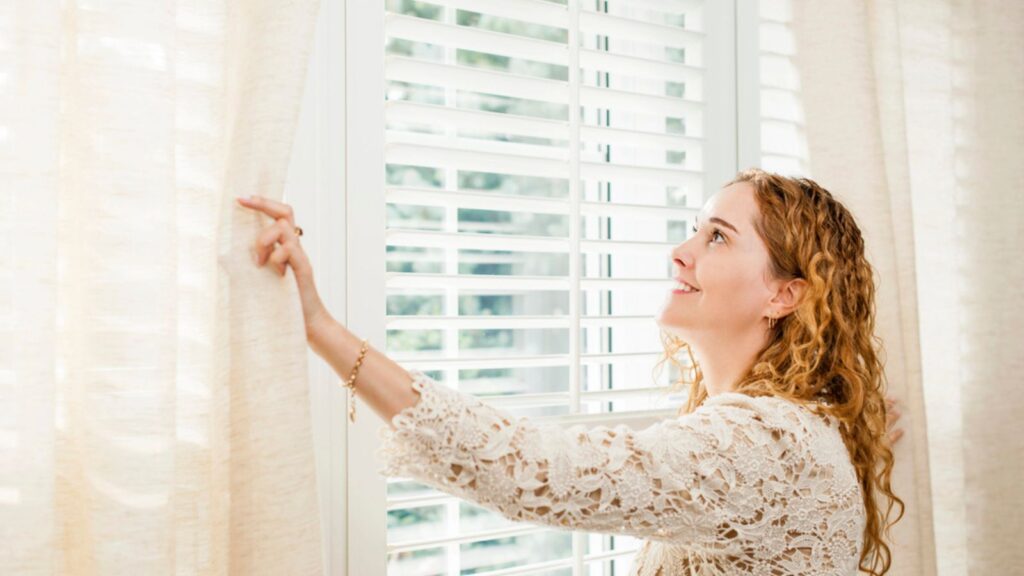 Smiling woman looking out window