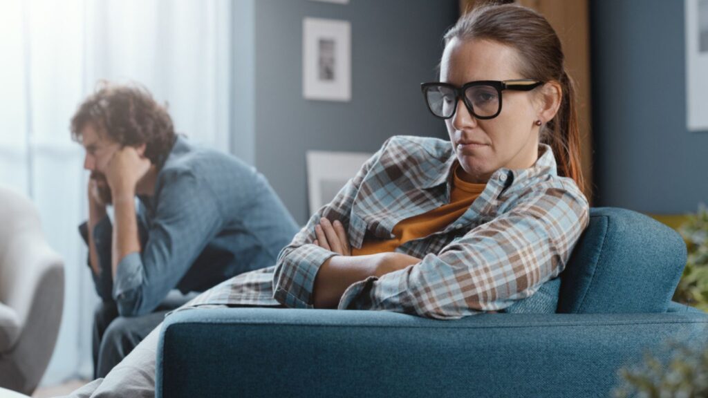 couple in the living room frowning sad silent treatment