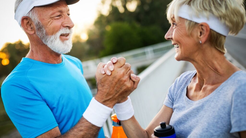 retired older couple playing sports tennis