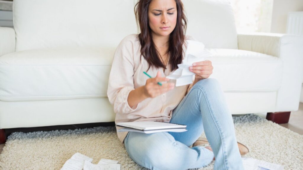 woman looking at her receipts and bills