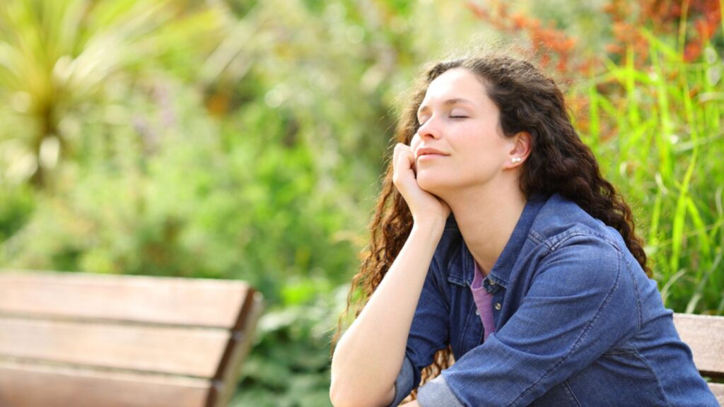 happy grateful woman outside eyes closed content