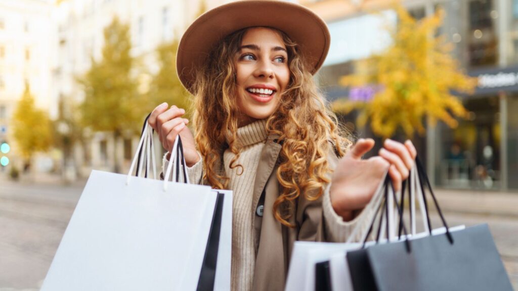 happy woman shopping on the street fall colors
