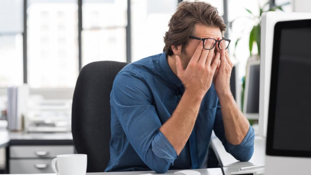stressed frustrated man at his computer with glasses