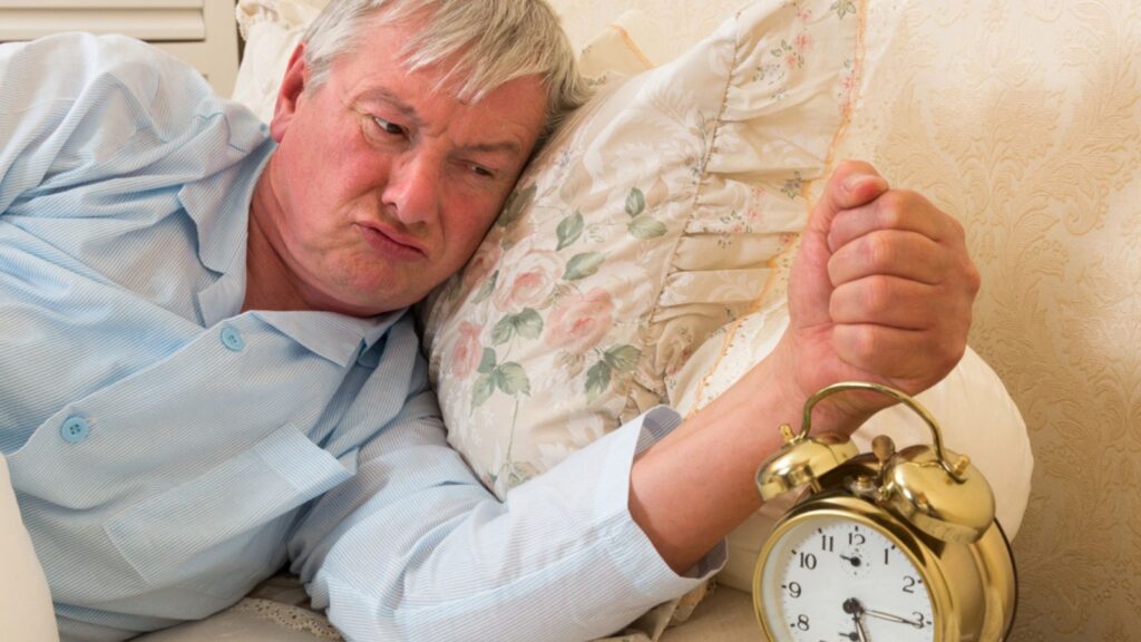 grumpy old man with an alarm clock