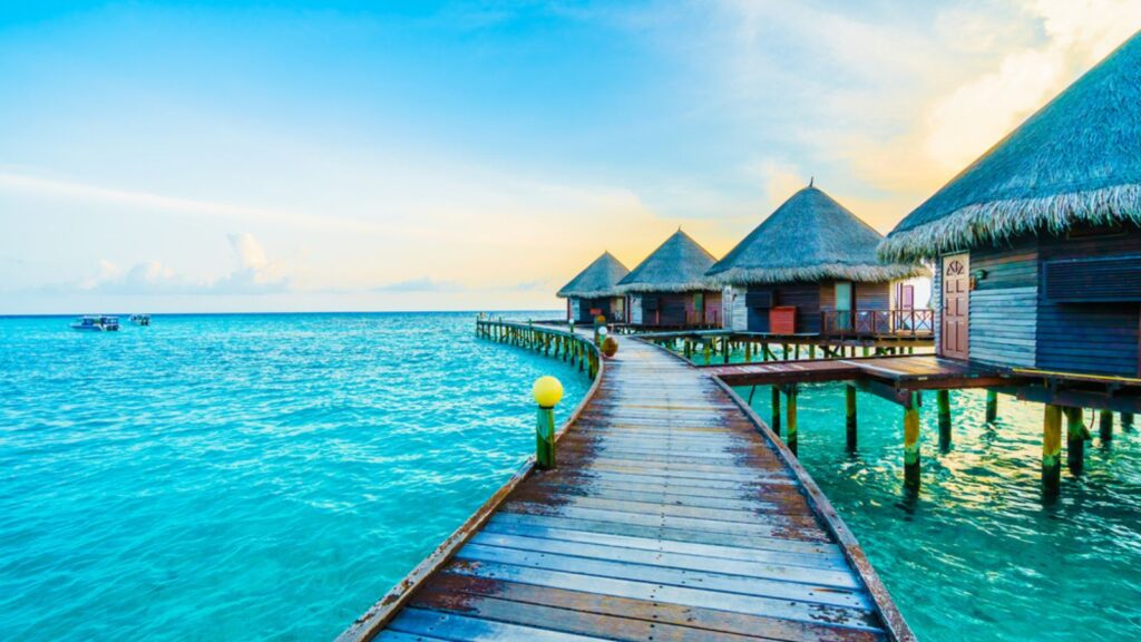 Beautiful Tropical resort hotel and island with beach and sea on a sky for holiday in Maldives island