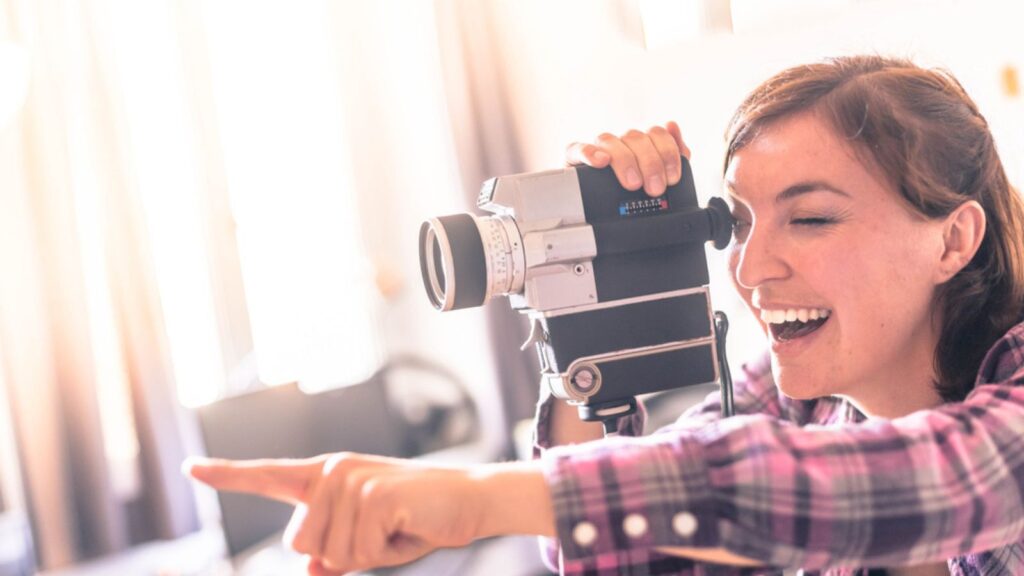 Filmmaker is doing a movie, vintage old movie camera