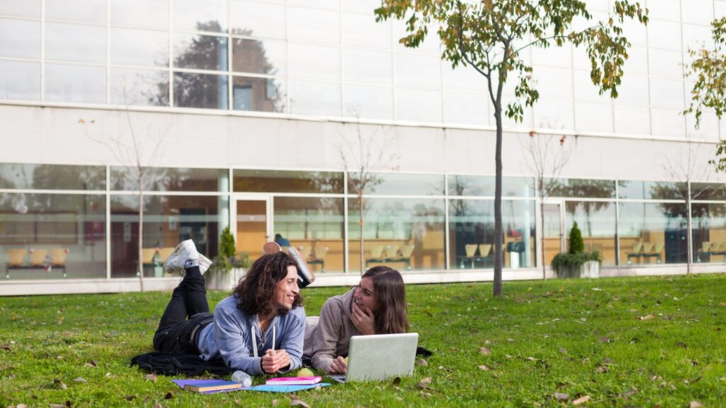 Two happy university students studying outdoor at the school campus Harvey Mudd College &ndash; Claremont, CA