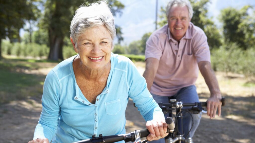 happy old couple retire riding their bikes