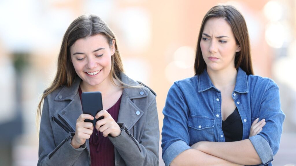 jealous friend on her phone