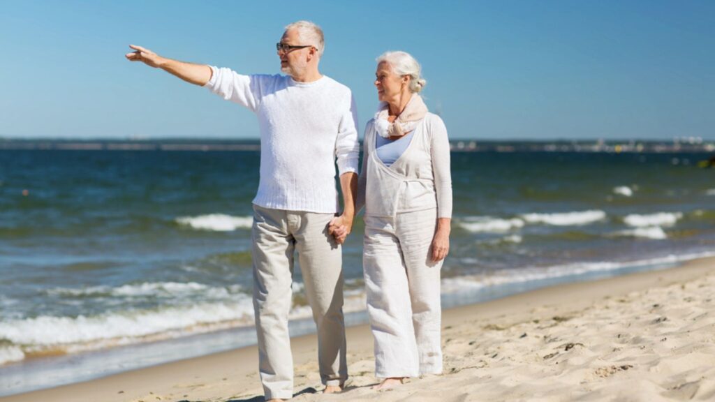 couple at the beach retired happy travel