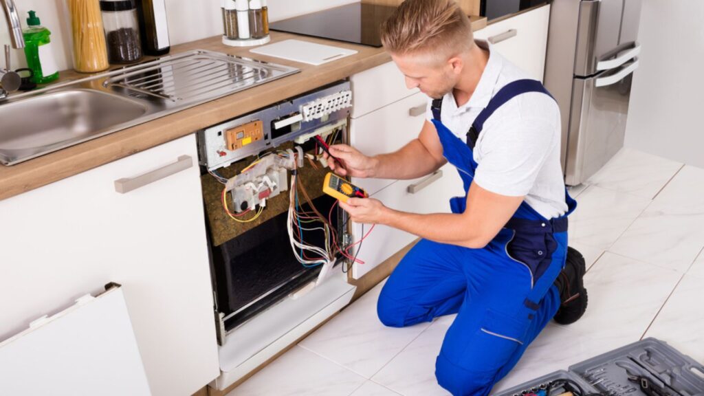 Young repairing man Fixing Dishwasher
