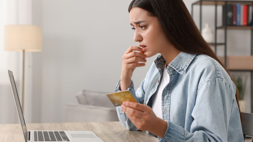 A stressed woman while talking with credit card operator