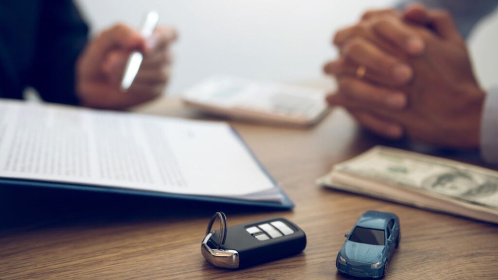Agent car salesman is explaining about the new car purchase contract and agreement to the car buyer.