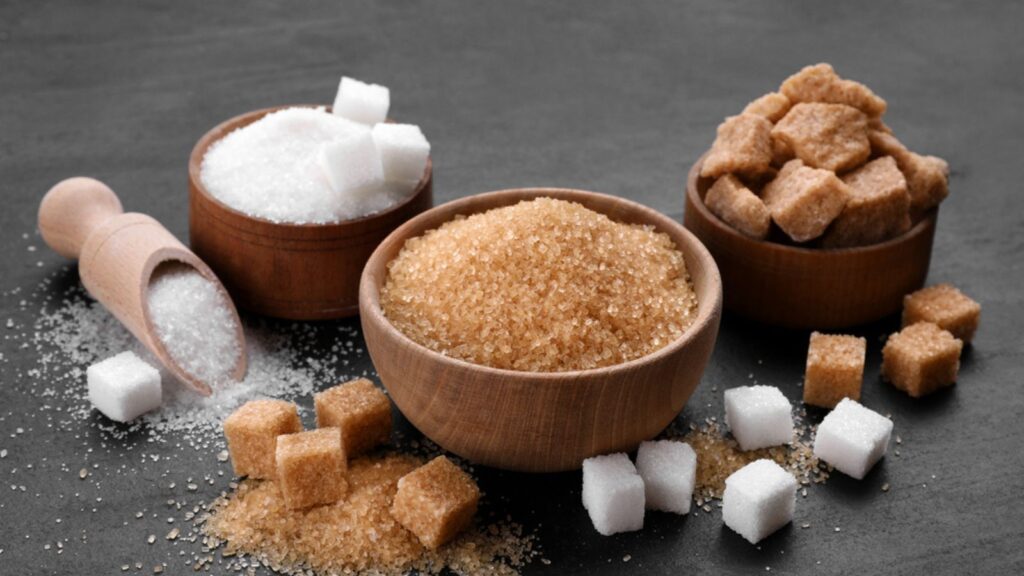 Different types of sugar on black table