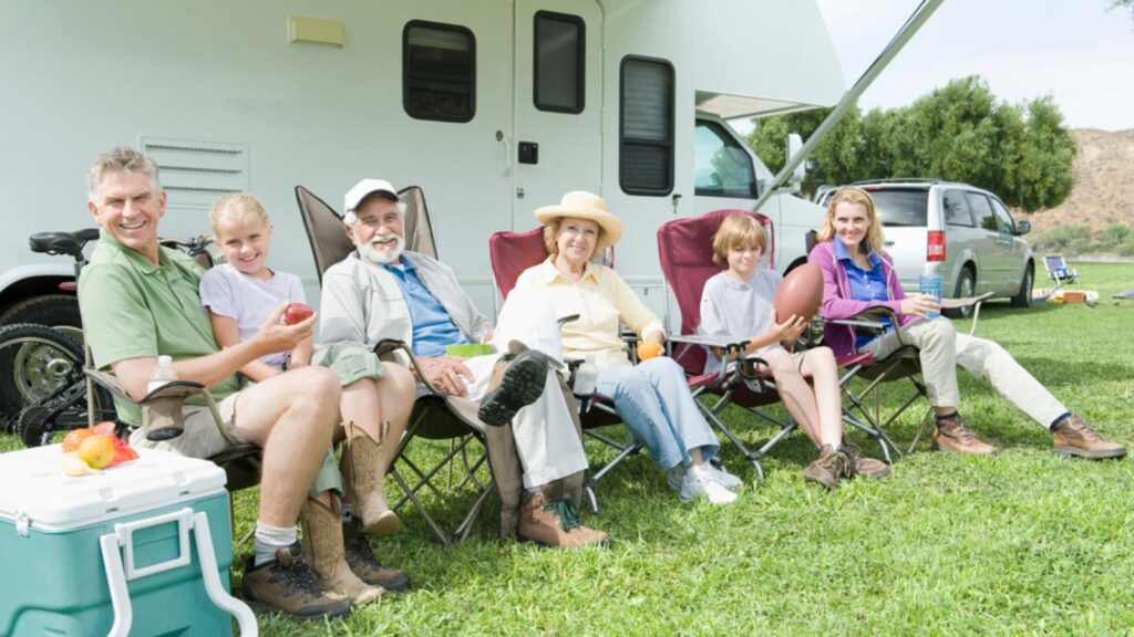 Family Sitting Outside RV Home 