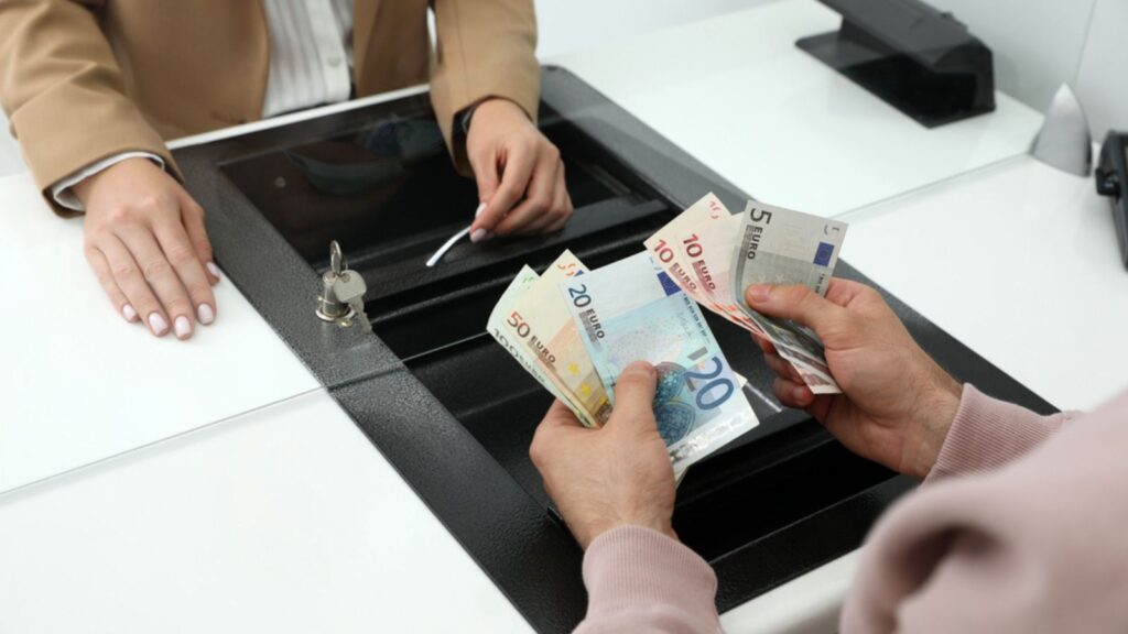 Man exchanging money in bank, closeup view