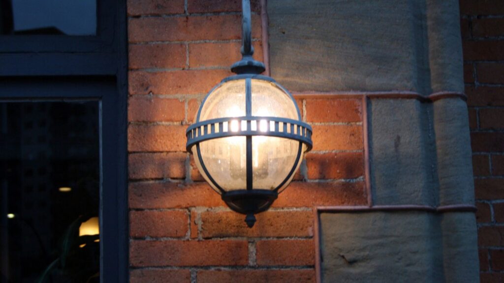 Old vintage lantern hanging on a brick wall