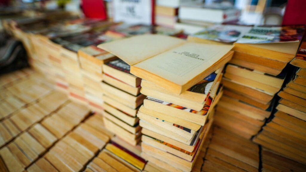 Piles of old classic books and novels in an outdoor bookstore in the centre of Paris, France