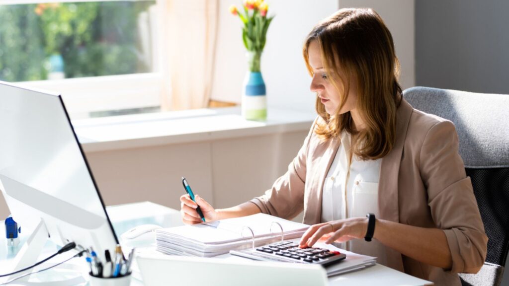 Professional businesswoman working on accounting with computer desk