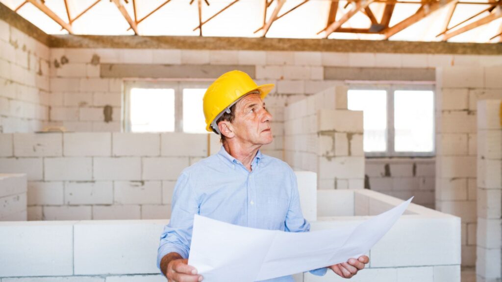Senior architect, Home Inspector or civil engineer at the construction site