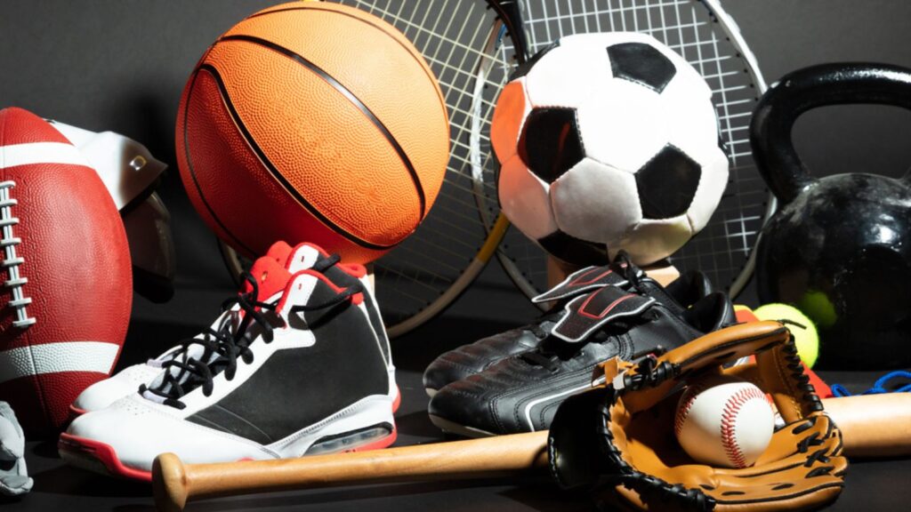 Variety Of Sport Balls And Equipment In Front Of Black Surface 