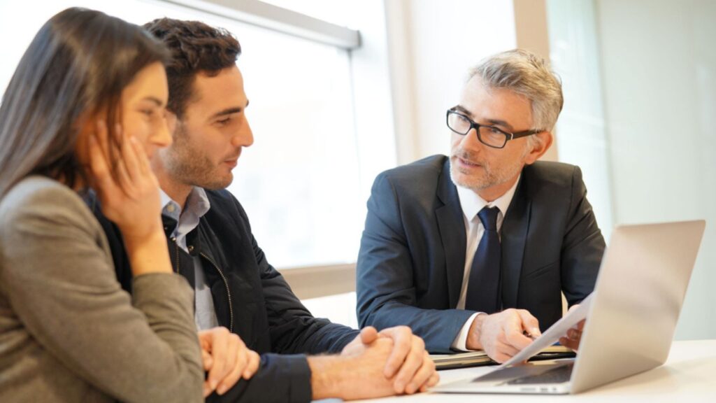 Young couple meeting financial advisor for home investment